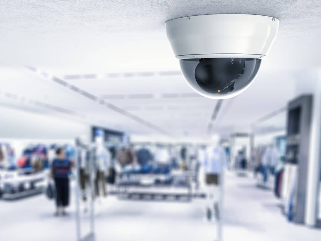 security camera cctv camera ceiling with retail shop background